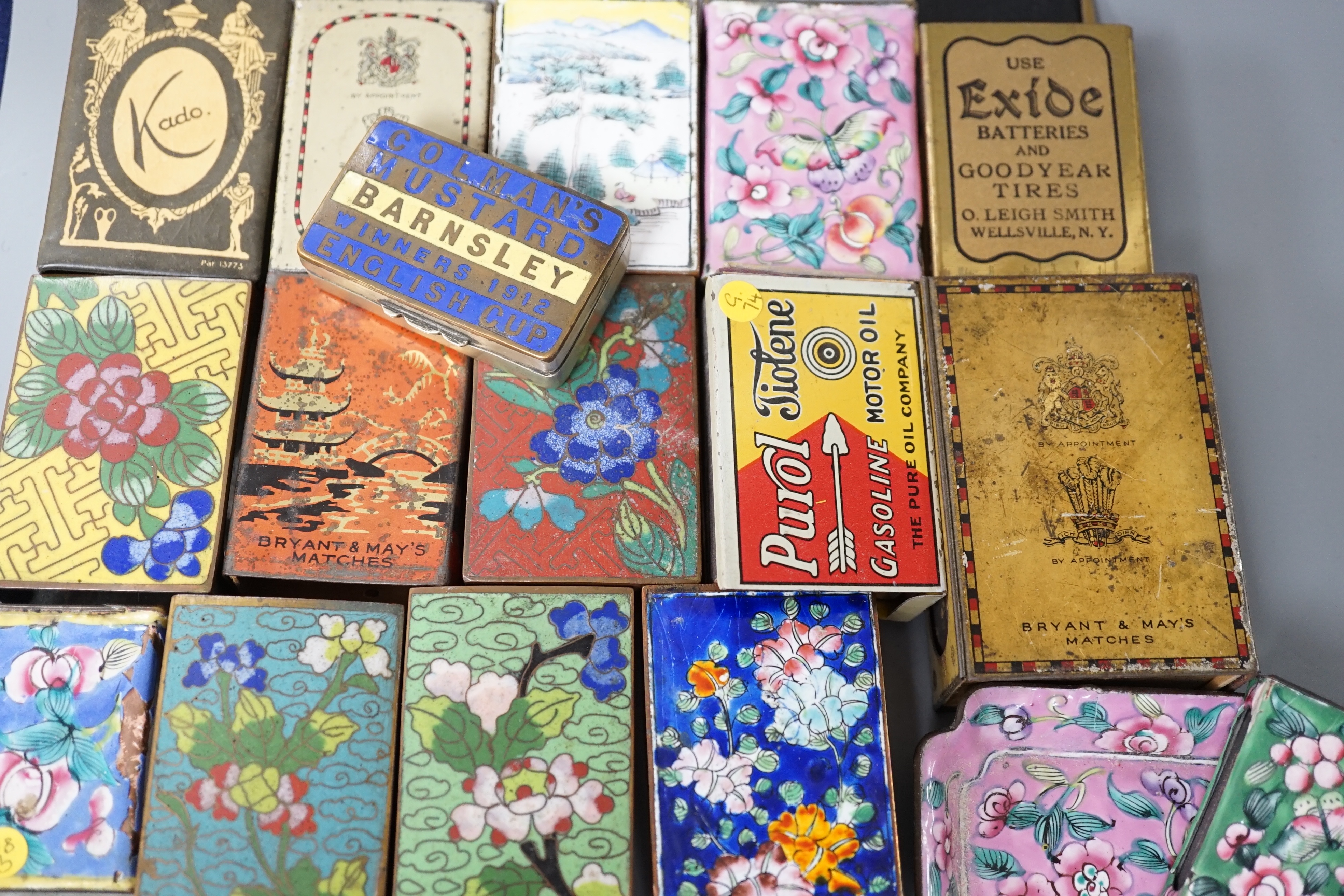 A collection of advertising and other enamelled metal match box holders